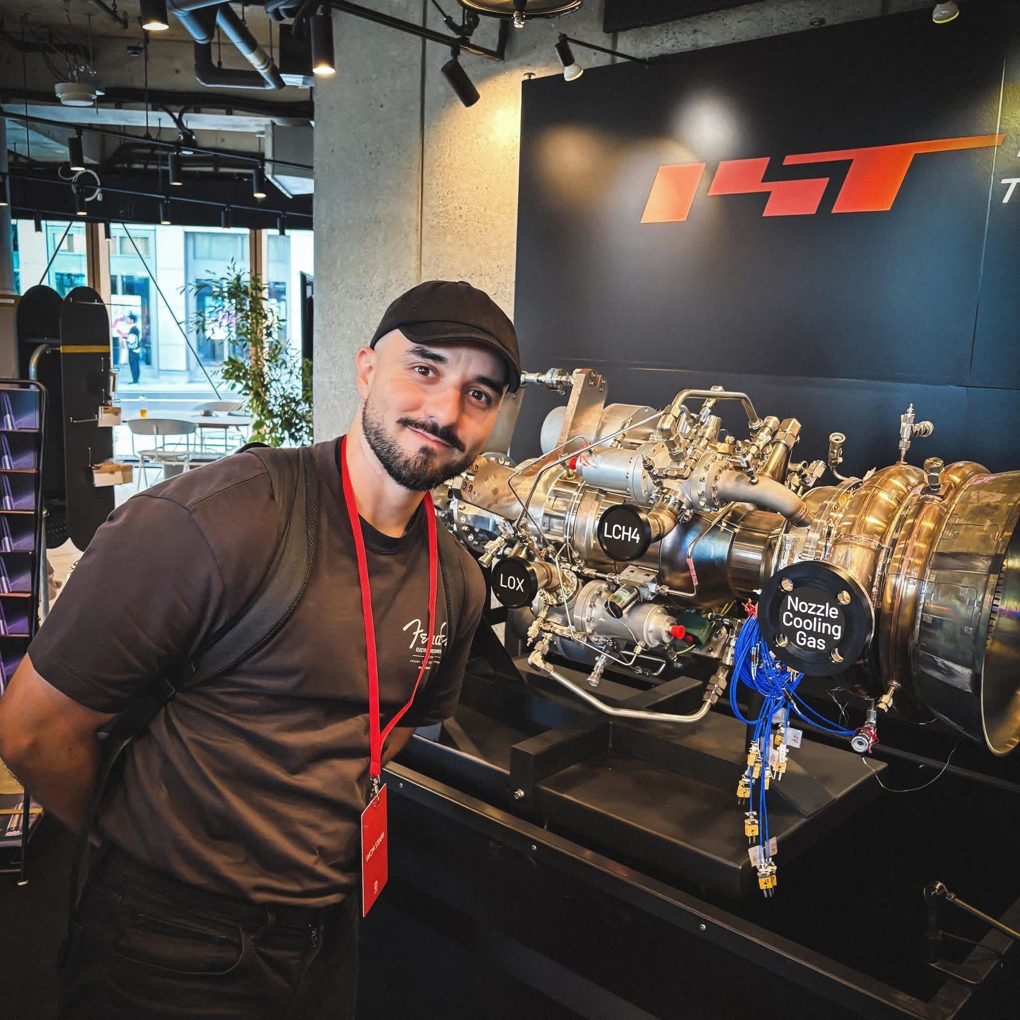 Vic next to a rocket engine.